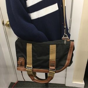 TUMI canvas and leather travel bag.